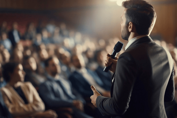 Person speaking in front of crowd